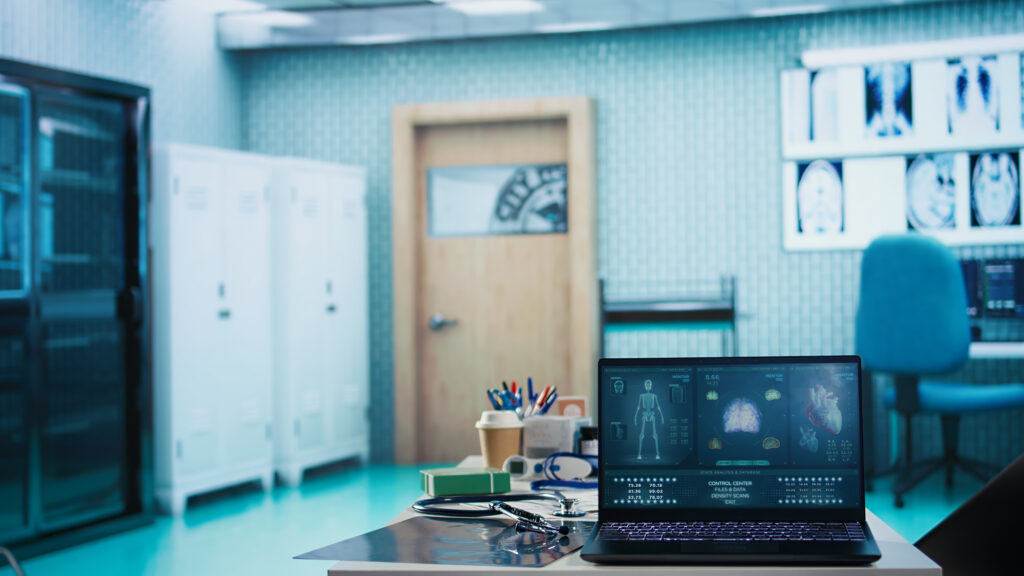 A doctors office with a laptop on a desk showing a humor