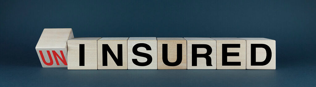 Wood blocks with letters spelling out 'UNINSURED'
