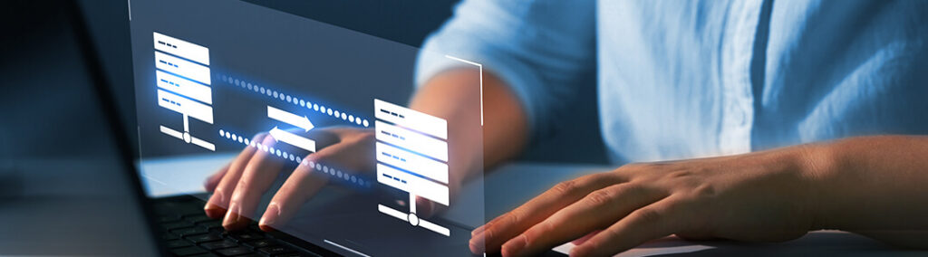 A person on a computer with a transferring data graphic.