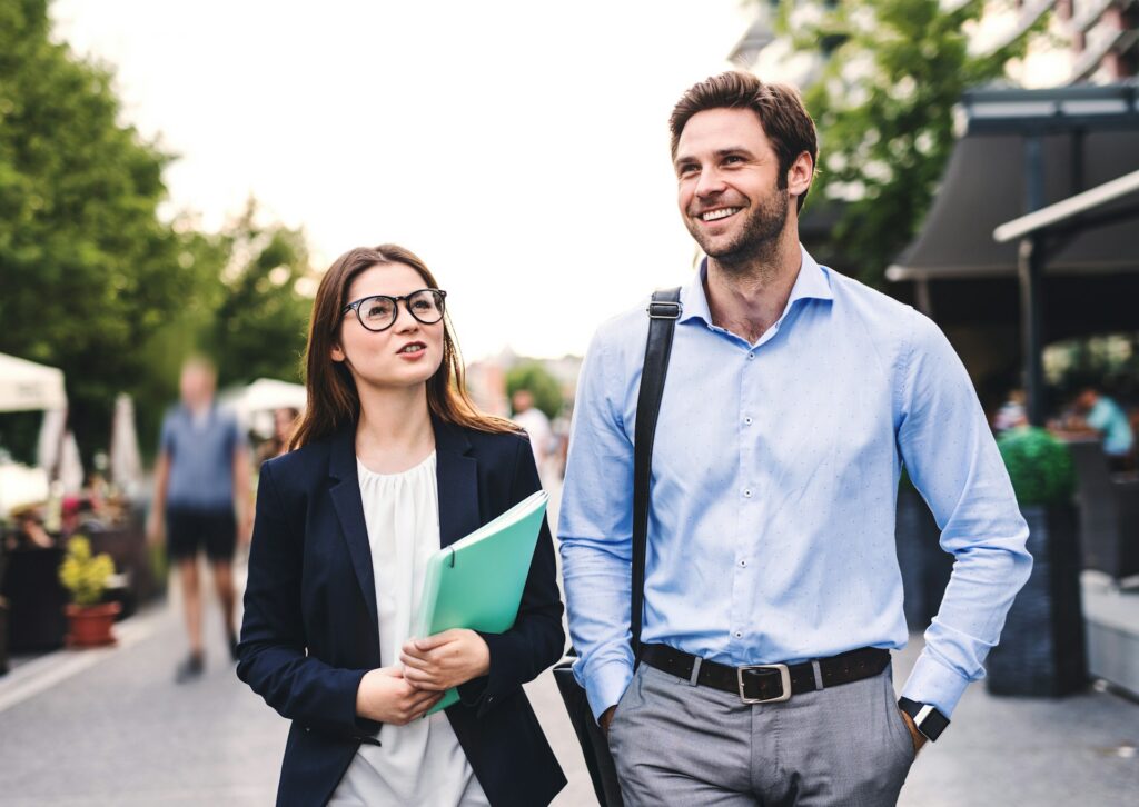 A man and a woman walking and communicating