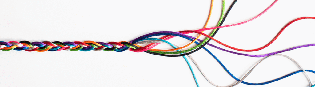 A braided rope with yellow, green, black, pink, red, purple, white, blue, and teal string unraveling